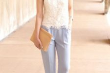 With light blue trousers, beige clutch and heeled shoes