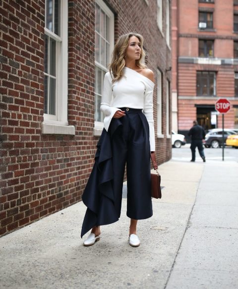With navy blue culottes, brown bag and white flat mules