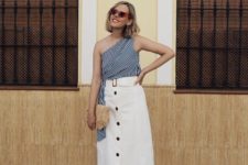 With white belted midi skirt, straw clutch and orange sandals