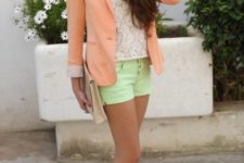 With white lace shirt, green shorts, beige clutch and beige shoes