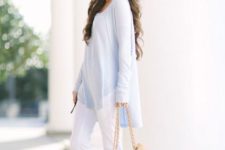 With white pants, light blue loose sweater and high heels
