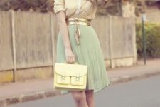 With yellow shirt, mint green pleated skirt, golden belt and brown shoes