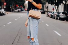 a black tee, blue ripped jeans, a blush crossbody bag and black strappy mules with block heels