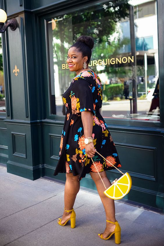 a bold look with a black floral print knee dress, mustard block heels and a fun citrus bag just wows