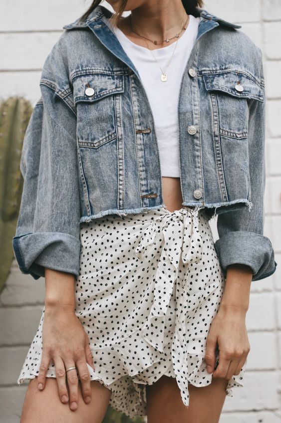 a chic girly outfit with a white crop top, a polka dot ruffle skirt, a blue cropped denim jacket