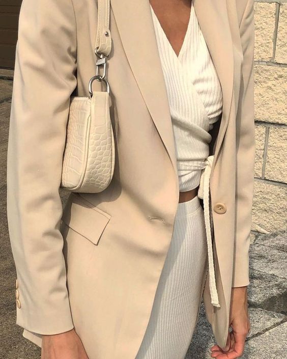 a creamy look with a wrap up crop top, a matching skirt, a neutral blazer and a white croco embossed bag