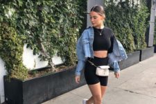 a daring summer look with a black crop top, black biker shorts, white sneakers, a blue cropped denim jacket
