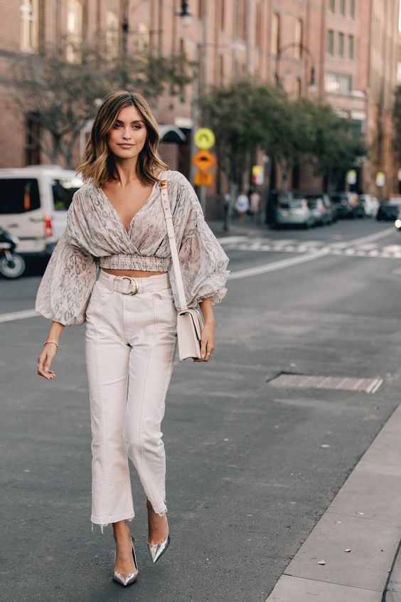 a floral cropped blouse with puff sleeve, tan pants, silver shoes and a neutral bag for a bold look