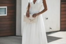 a gorgeous white cotton midi dress with a highlighted waist, ruffle cap sleeves, tan shoes and a white clutch