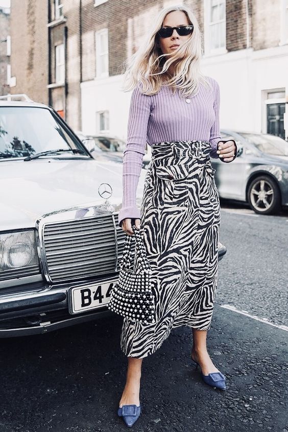 a lilac long sleeve top, a zebra skirt, an embellished pearl bag and navy buckle kitten heel mules