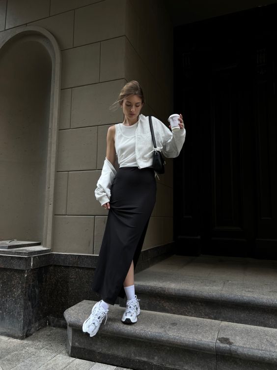 a lolvely black and white look with  sleeveless top, a black maxi skirt, a white cropped jacket, white trainers and socks and a black baguette bag