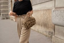 a minimalist work look with a black tee, tan pants with a high waist, black square toe sandals and a woven bag