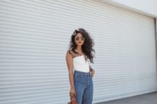 a party look with a white strapless top with a deep neckline, blue cropped jeans, metallic pointed toe shoes and a brown bag