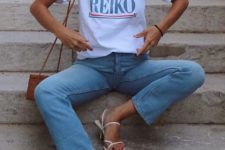 a printed tee, blue cropped jeans, white square toe sandals, a brown bag and layered necklaces