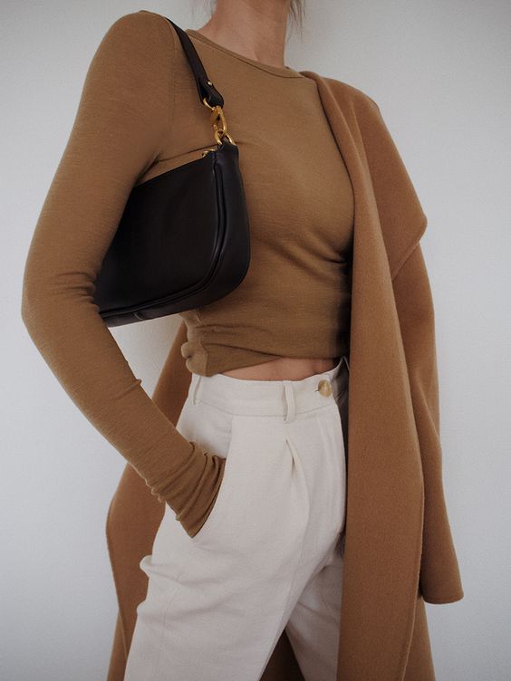 a refined and simple look with a camel long sleeve top, white trousers, a camel coat and a black baguette bag is lovely
