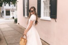 a romantic vintage-inspired white midi dress with short sleeves, two tone slingbacks and a wicker bag