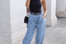 a sexy outfit with a black halter neckline top, baggy jeans, black lace up shoes and a black bag