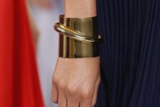 a statement minimalist bracelet in gold looks really unusual and bold and will elevate any outfit