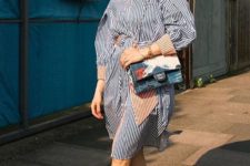 a striped overiszed knee shirtdress, yellow sunglasses, a printed bag and red square toe sandals