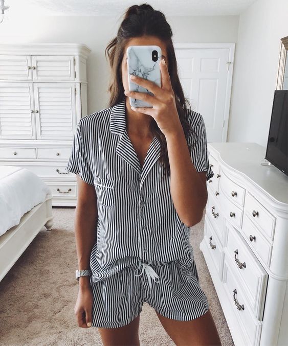 a striped romper styled as pajamas is a very cool and fresh take on traditional home looks