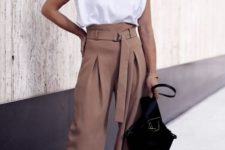 a stylish and trendy work look with a white padded shoulder tee, taupe high waisted palazzo pants, a black bag