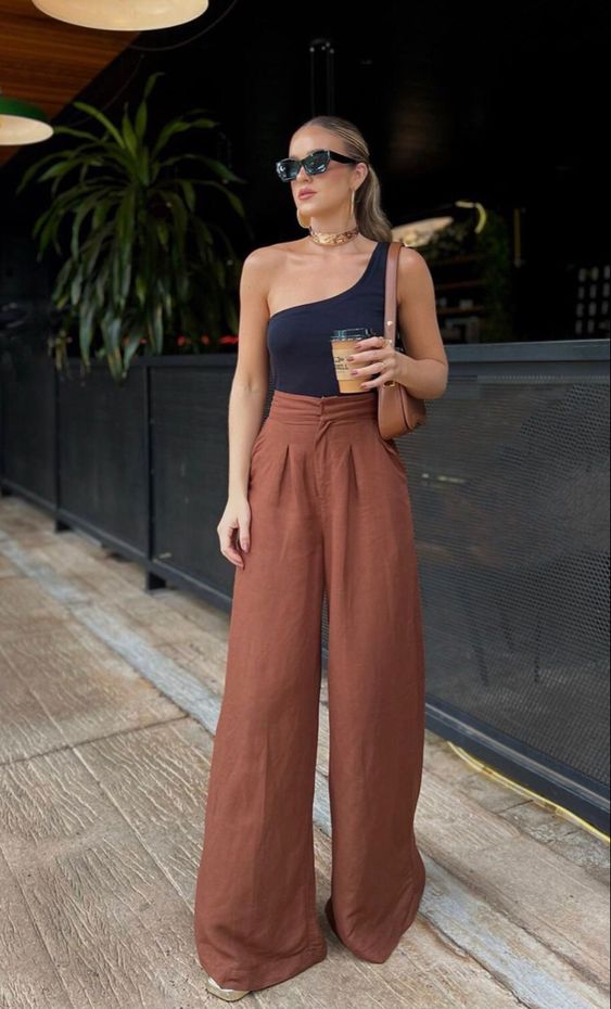 a summer look with a navy one shoulder top, rust high-waisted palazzo pants, a brown baguette bag and platform slippers
