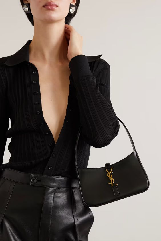 a total black look with a button down polo top, leather pants and an elegant baguette bag for spring or fall