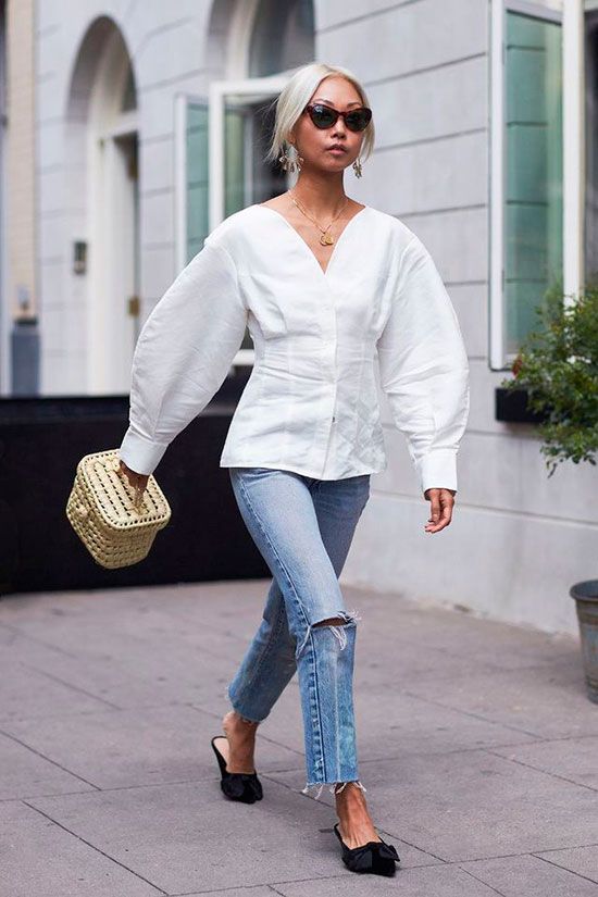 a white blouse with creative sleeves, blue jeans, black bow kitten heel mules and a small box bag for spring