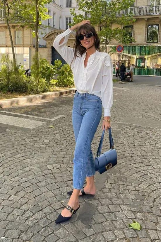 a white button down, blue jeans, black kitten heel mules and a navy bag are a cool combo for spring