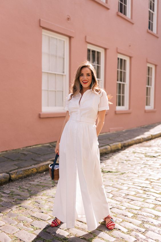 a white cotton button up maxi dress with short sleeves, a basket bag and red sandals