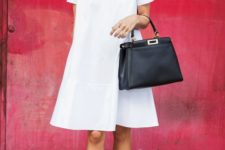 a white cotton knee dress with short sleeves, white flats and a black bag for a minimal look