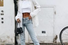 a white crop top, neutral cropped jeans, white pointed toe shoes and a striped blazer
