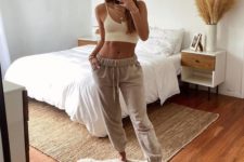 a white crop top, neutral cropped joggers and layered necklaces to look cool and a bit boho