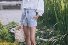 a white light shirt with long sleeves, blue plaid shorts, a woven bag and brown slippers for a hot day