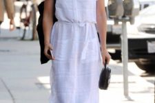a white midi shirtdress with short sleeves, pockets, black slipper mules and a black bag