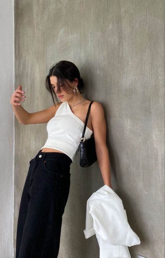 a white one-shoulder top, black jeans, a white shirt and a black baguette bag are a lovely and cool look for summer