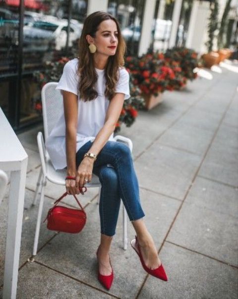 a white oversized t-shirt, blue cropped skinnies, red slingbacks and a red bag plus statement earrings