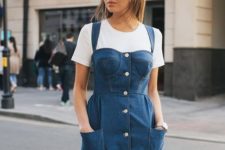 a white t-shirt and a blue mini denim button up dress wiht a bustier for a catchy look