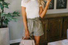 an everyday outfit with a white tee, grey striped shorts, a blush bag and white sneakers is very comfy
