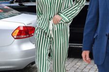 Gigi Hadid in a green and white striped pajamas suit, white heels and glasses