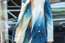 Gigi Hadid wearing a dip dyed blue and white suit and pastel blue sunglasses to highlight the color