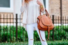 With beige loose shirt, white pants and brown leather bag