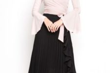 With black pleated midi skirt and black ankle strap high heels