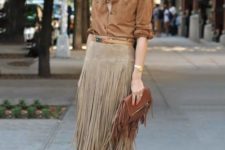 With brown button down shirt, fringe skirt and beige high heels