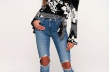 With distressed jeans and black lace up high heels