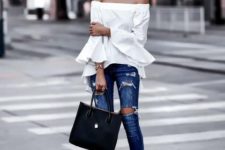 With distressed jeans, black tote bag and black pumps
