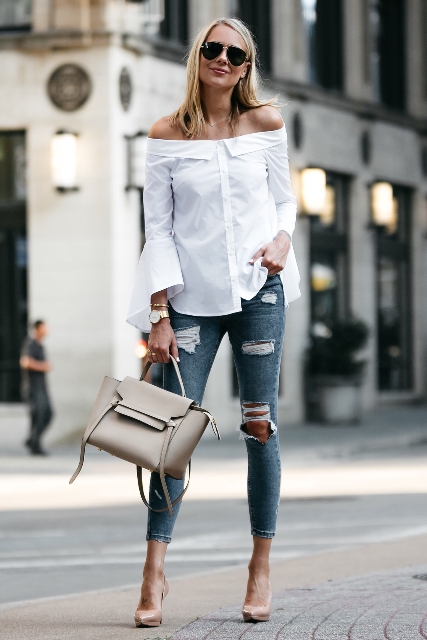 With distressed jeans, gray bag and beige high heels