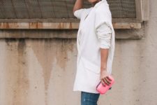 With distressed jeans, pink clutch and white loose blazer