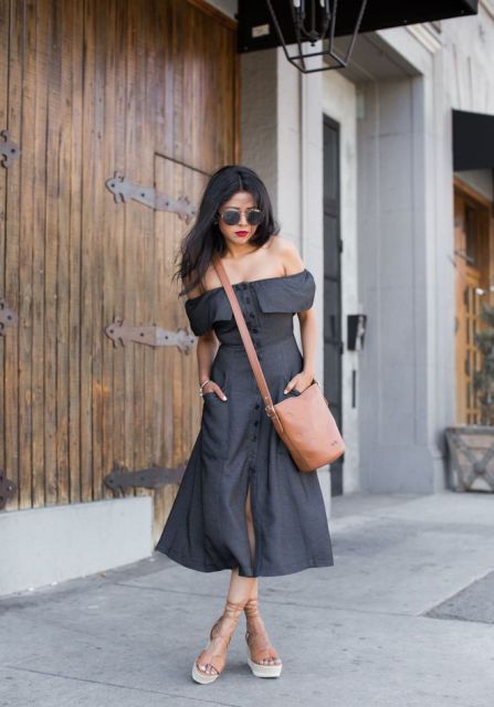 With gray off the shoulder midi dress and brown bag