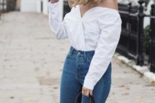 With high-waisted jeans and black bag